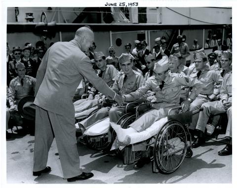 Dwight D. Eisenhower greets the hospitalized veterans on the Presidential Yacht, USS Williamsburg June 25, 1953 [72-351-3]